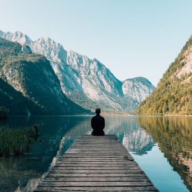 Man sitting on grey dock